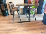 a table and chairs in a room with wood flooring
