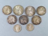 six different types of coins are arranged in a circle