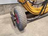 a cart with a tire and a hose attached to it