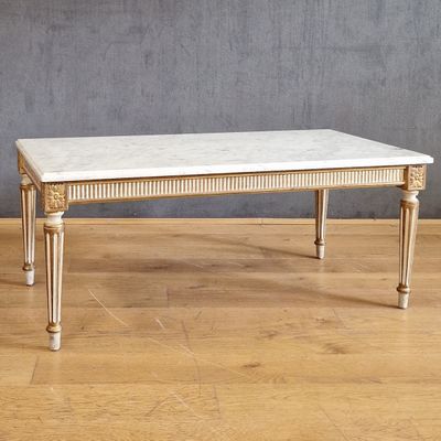an image of a marble topped coffee table on a hard wood floor