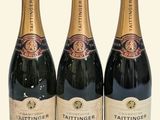 three bottles of champagne sitting next to each other on a table