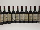 six bottles of wine are lined up in a row on a table