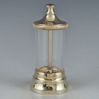 a silver clock with a glass cover on it