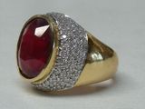 an image of a ring with a red stone surrounded by white diamonds