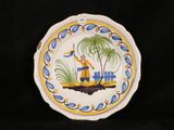 a plate with a picture of a man on a boat