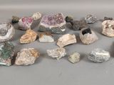 several different colored rocks and stones on a gray surface