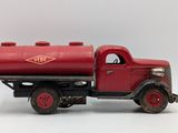 a red toy truck with a red tank on the back of it