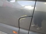 a cat that is sitting on the side of a car