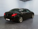 the back of a black car is parked in a large room