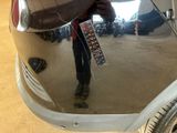 a reflection of a person in a mirror of a car