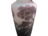 a vase with a purple flower on it on a white background