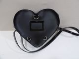 black leather heart shaped purse with metal handles and a black strap