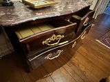 a marble top desk with a drawer underneath it