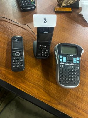 several cell phones are sitting on a table next to each other