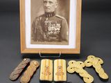 an old photo of a picture of a man in uniform surrounded by other items