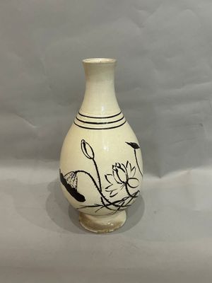 a white vase with black designs on it on a white background