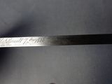 a hand holding a knife that has writing on it