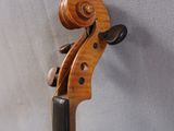 a close up of a violin on a stand against a white background