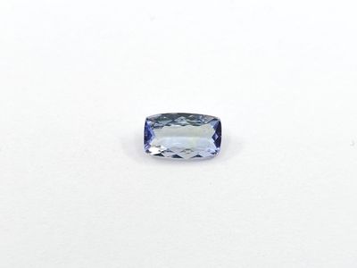 a close up of a blue sapphire stone on a white surface