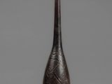 a black vase with a pattern on the top of it