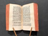 an open book with two wooden sticks sticking out of it
