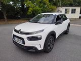 the white citrole is parked on the street in front of a house