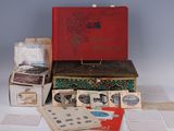 a red suitcase sitting on top of a pile of old books