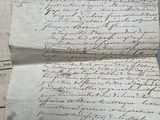 an old letter is sitting on top of a piece of paper