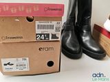 two boxes of shoes and a pair of boots on a table