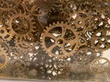 a close up picture of a clock with gears on it