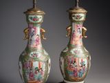 pair of antique chinese vases on stands on a grey background