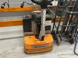 a forklift that is sitting on the floor in a warehouse