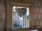 un miroir accroché au mur au-dessus de la cheminée d'une pièce