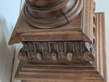 a clock that is sitting on top of a wooden stand