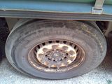 a tire that is sitting on the side of a truck