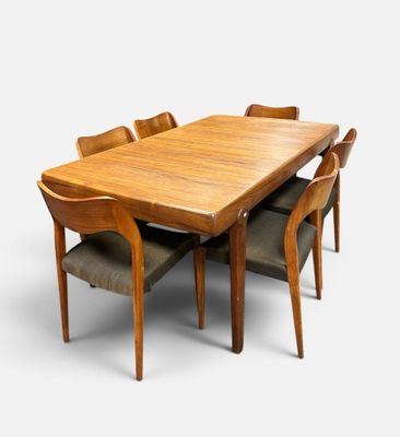 an image of a wooden table with six chairs around it