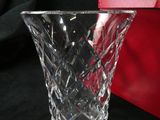 a glass vase sitting next to a red box on a table