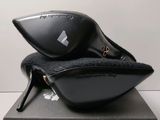 the black shoes are sitting on top of the black box