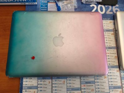 two laptops that are sitting on a table next to each other