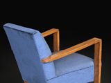 an image of a blue chair with a wooden frame on a black background