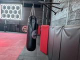a punching bag hanging from the ceiling in a gym