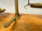 a scale with a spoon and fork on it on a table