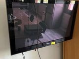 a flat screen tv hanging on the wall in the room