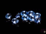 some very pretty blue diamonds on a black surface