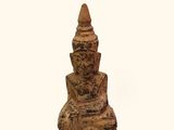 a small statue of a person sitting on a chair
