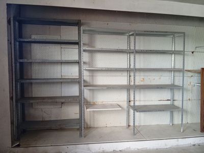 a empty shelf in the middle of an empty room