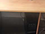 a computer desk with a keyboard and a monitor on it