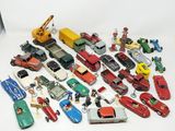 a lot of toy cars and trucks on a white surface