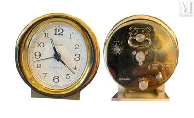deux horloges placées l'une à côté de l'autre sur une surface blanche