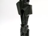 a black sculpture on a white surface with a white background